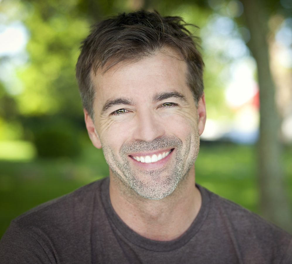 Smiling man enjoying confident, natural-looking teeth