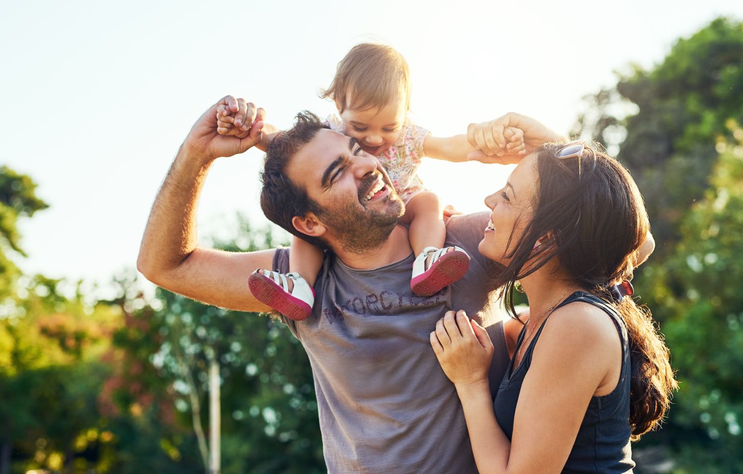 Happy family laughing together outdoors